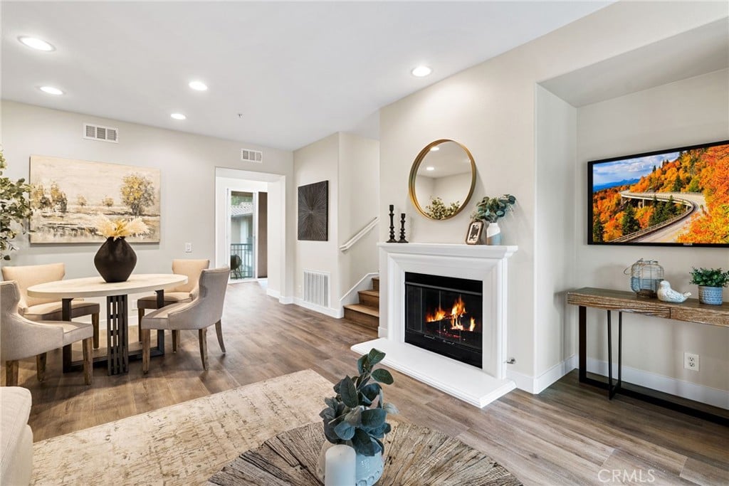 A dining area beside a white fireplace